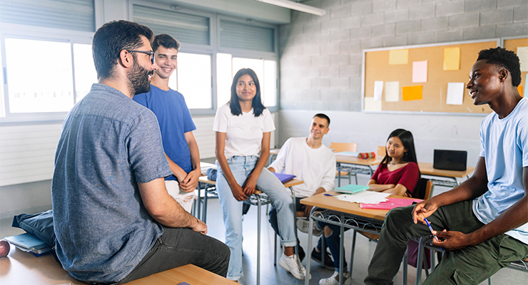 Group of people in a classroom interacting with each other.